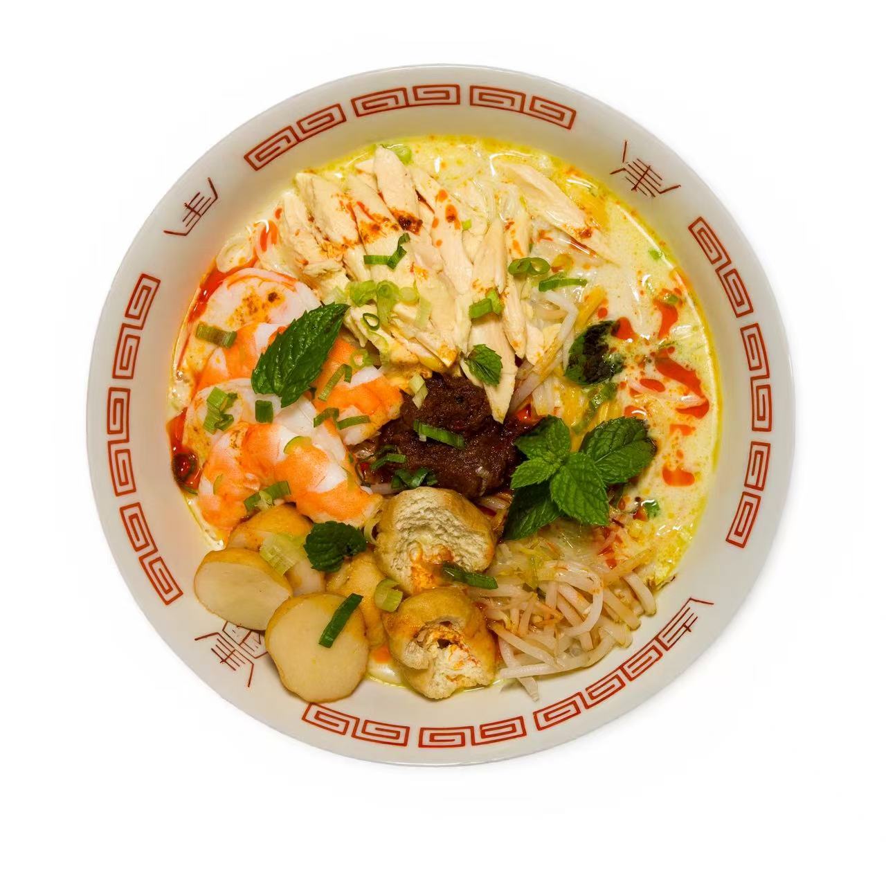 White curry laksa — pale coconut broth, poached chicken, prawns, tofu puff, mint